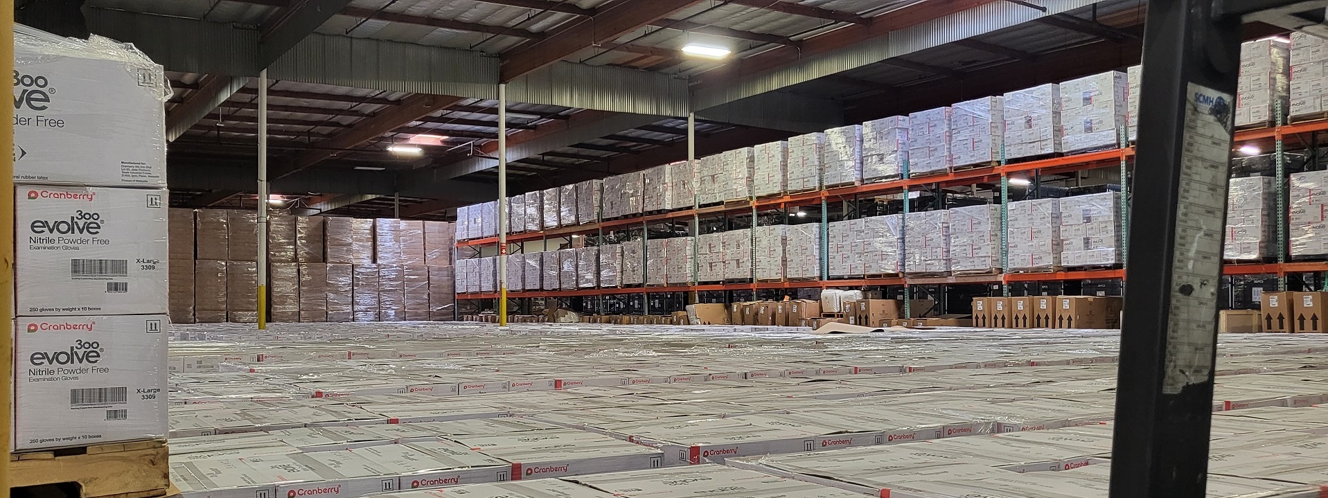 Warehouse with stacked boxes of non-US manufactured nitrile gloves